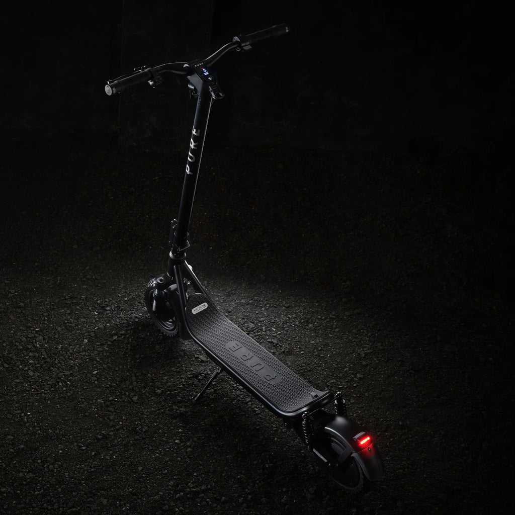 Black electric scooter on a dark background